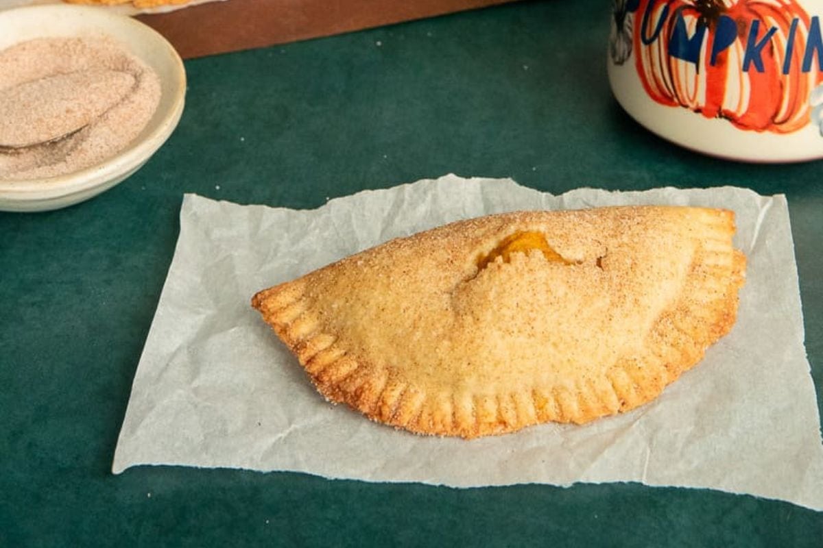 Pumpkin empanada on a paper. 