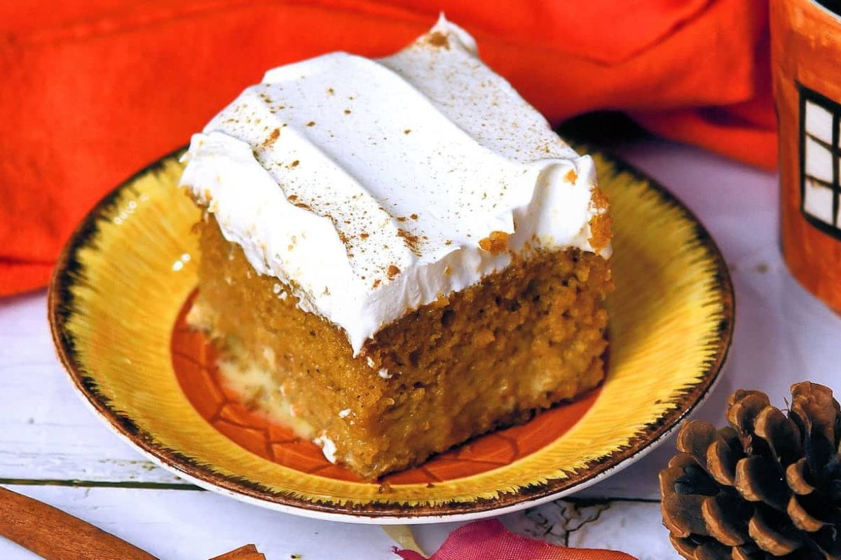 Slice of pumpkin tres leches cake on a plate. 