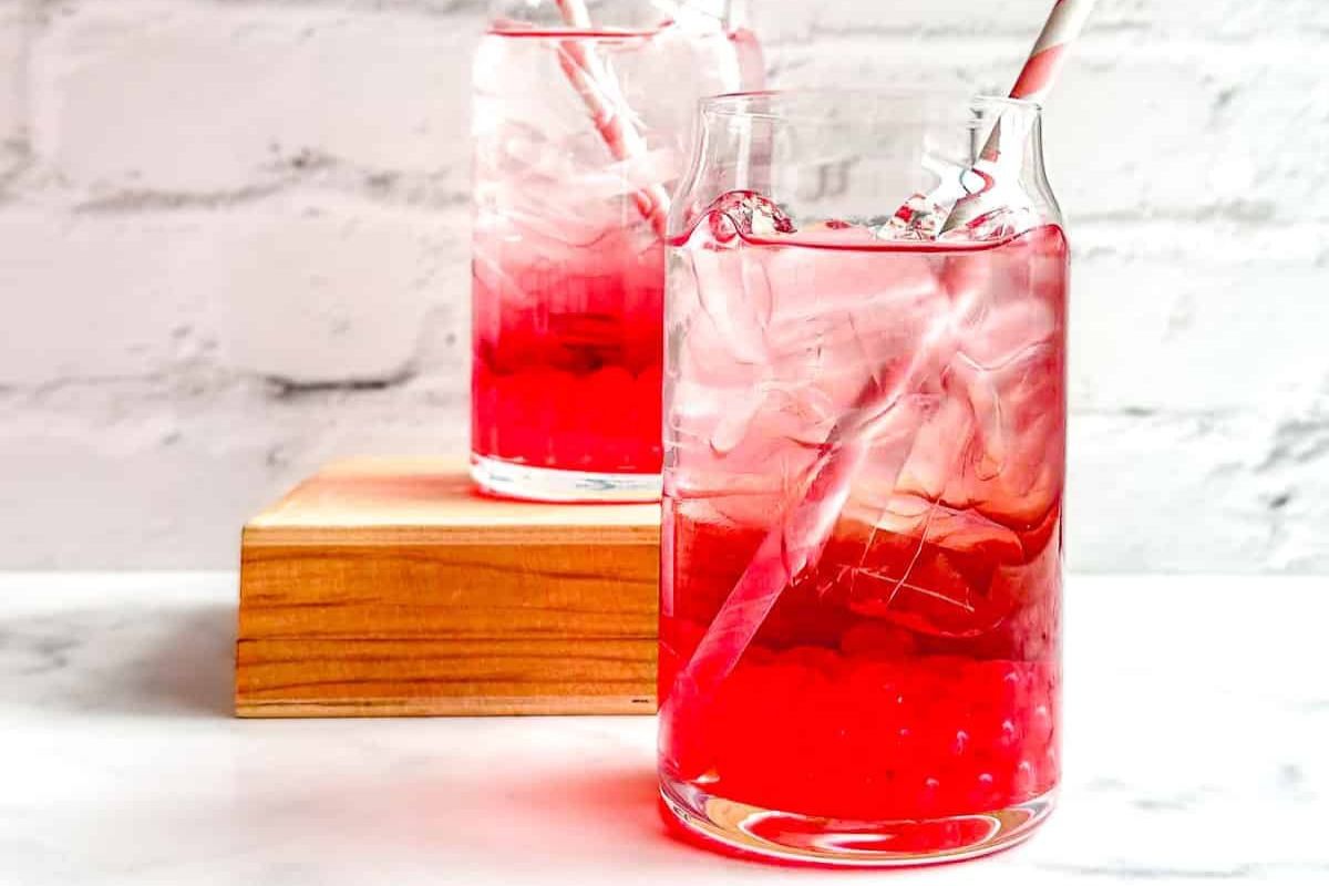 Red drinks in glasses with straws. 