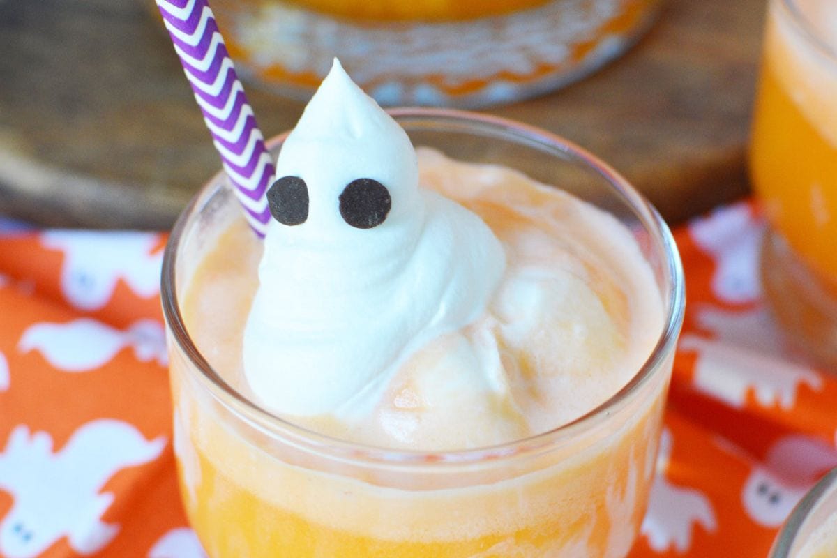 Orange punch with a whipped cream ghost on top. 