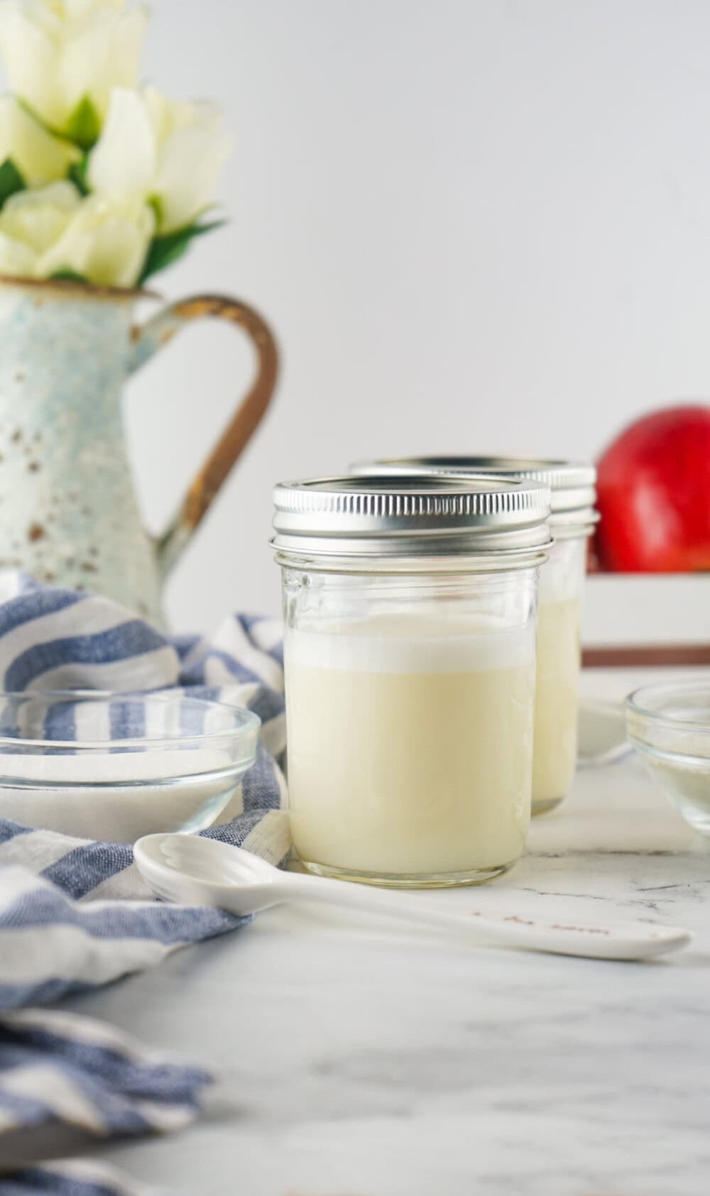 Jars of sweetened condensed milk on a table. 