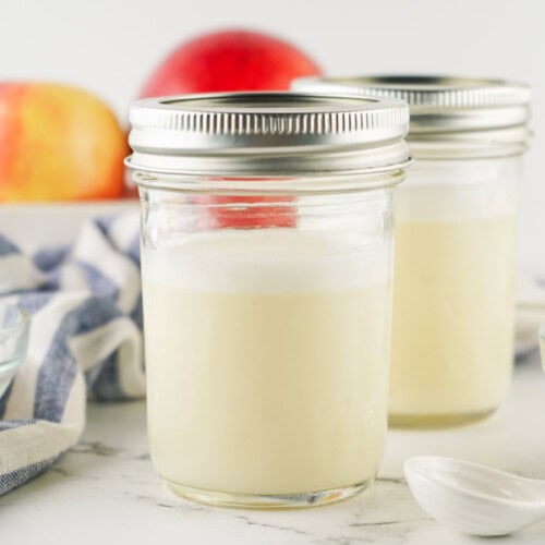 Two jars of homemade sweetened condensed milk.