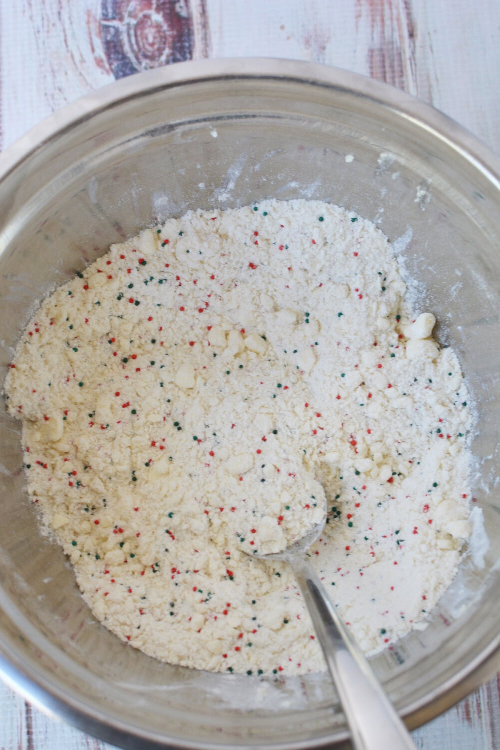 Stirring nonpariels into flour butter mixture. 