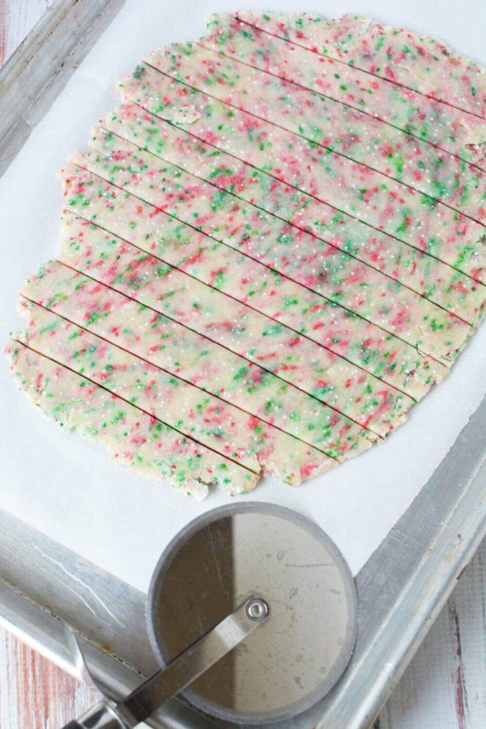 Cutting shortbread dough into triangles. 