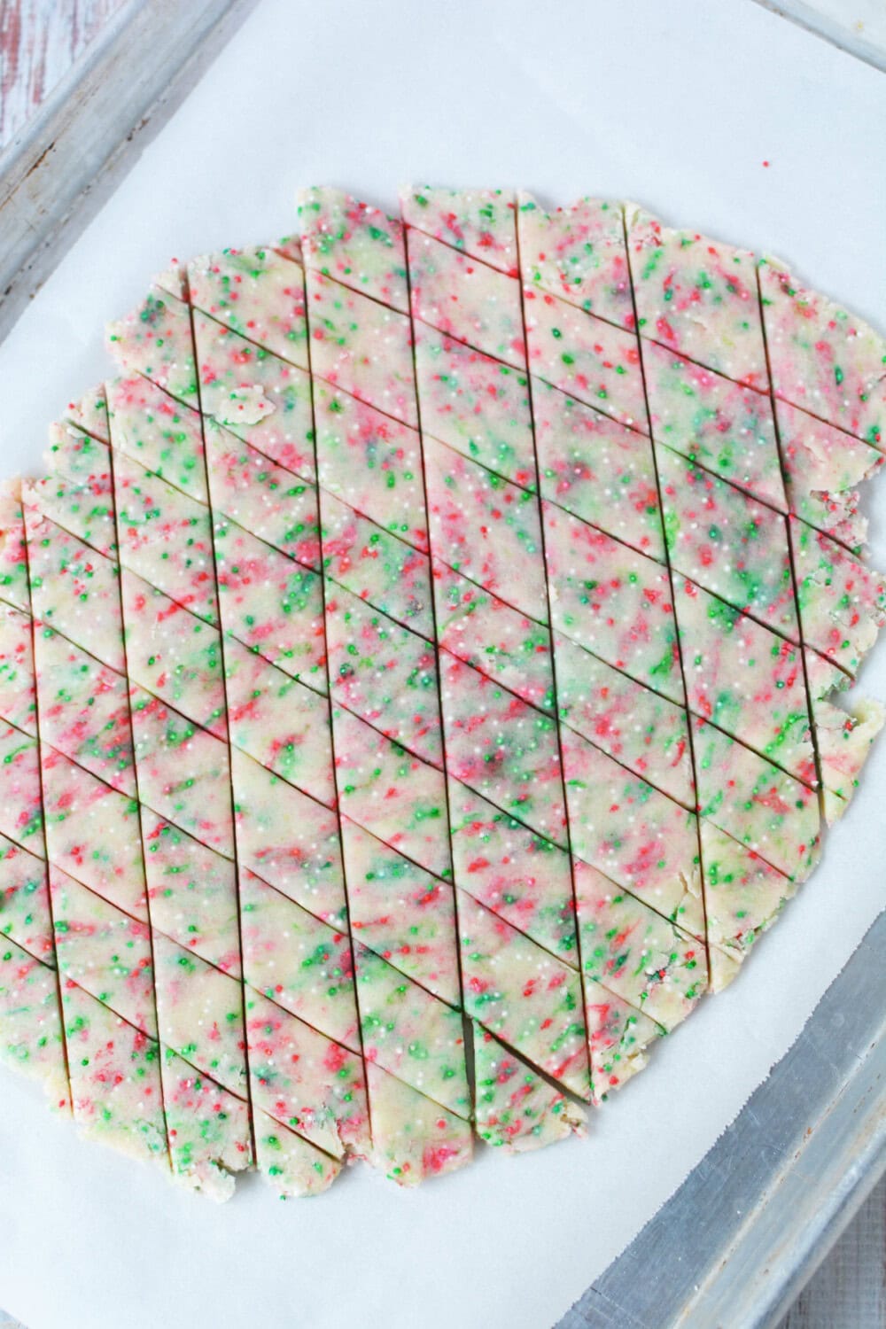 Shortbread bites dough cut into tiny triangles. 