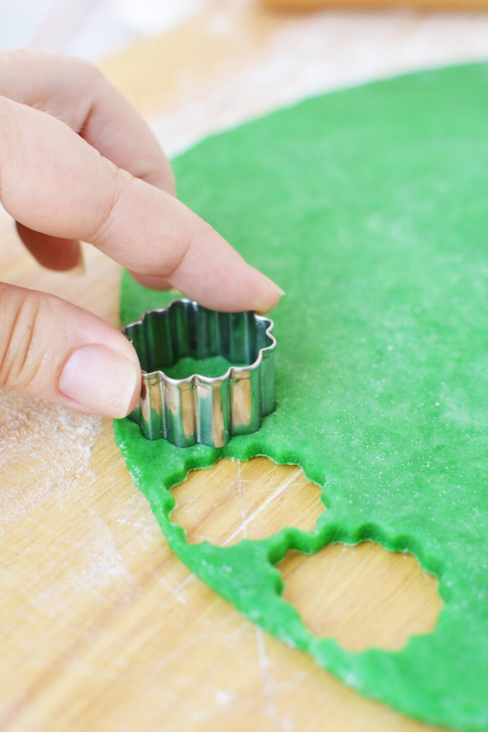 Cutting dough with small cookie cutter. 