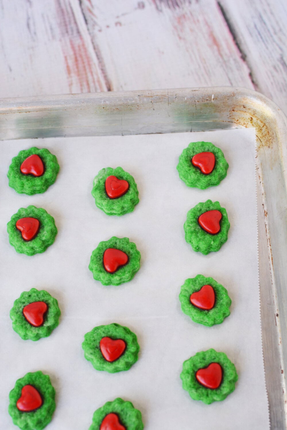 Grinch shortbread cookies on a baking pan.