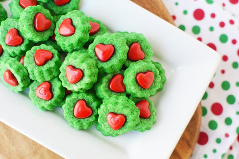 Grinch shortbread bites on a white tray. 