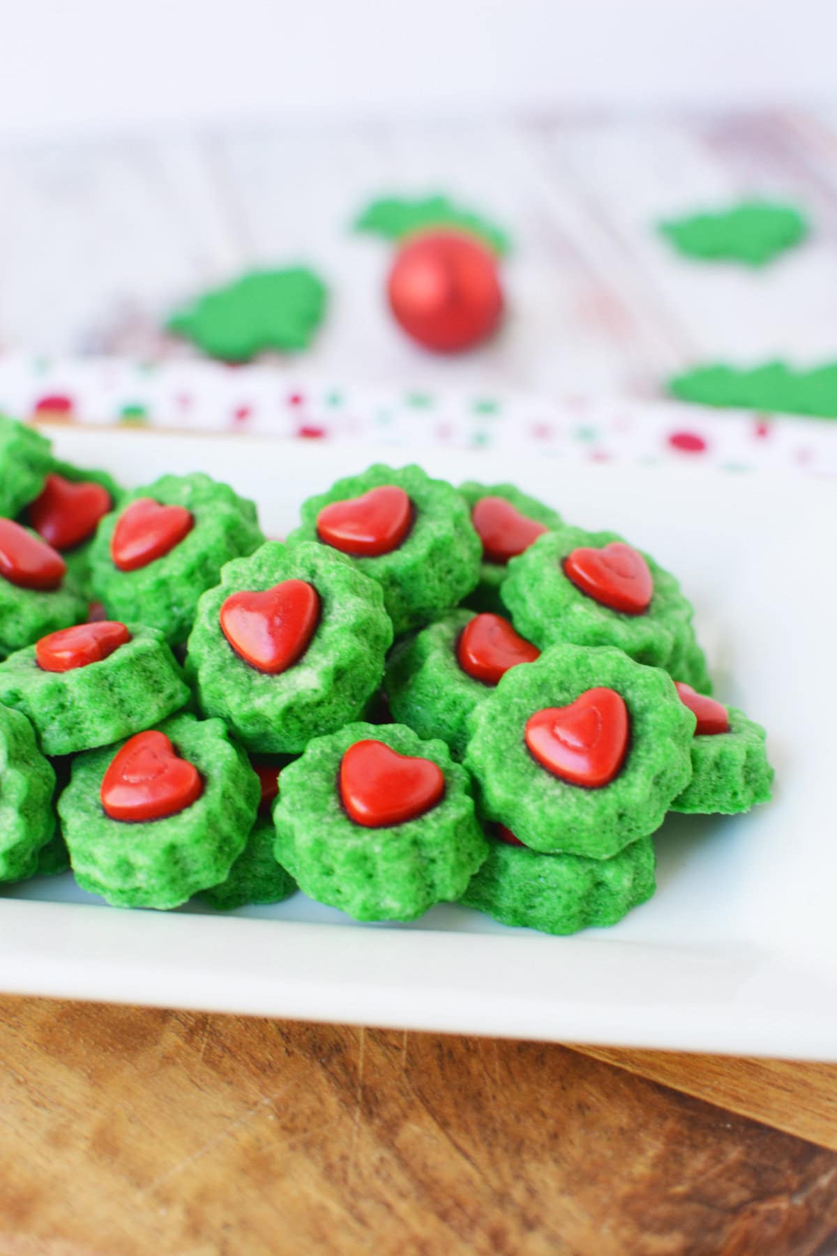 Grinch-themed mini shortbread bites on a tray.