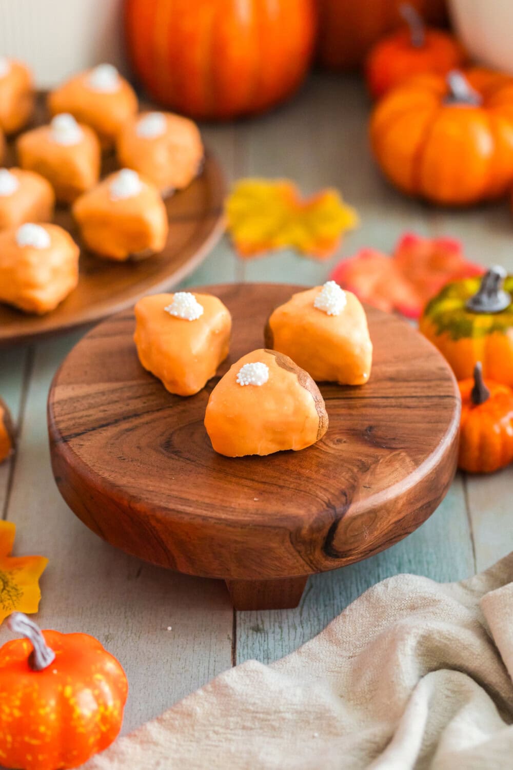 Pumpkin pie cake bites on a board with more in the background.