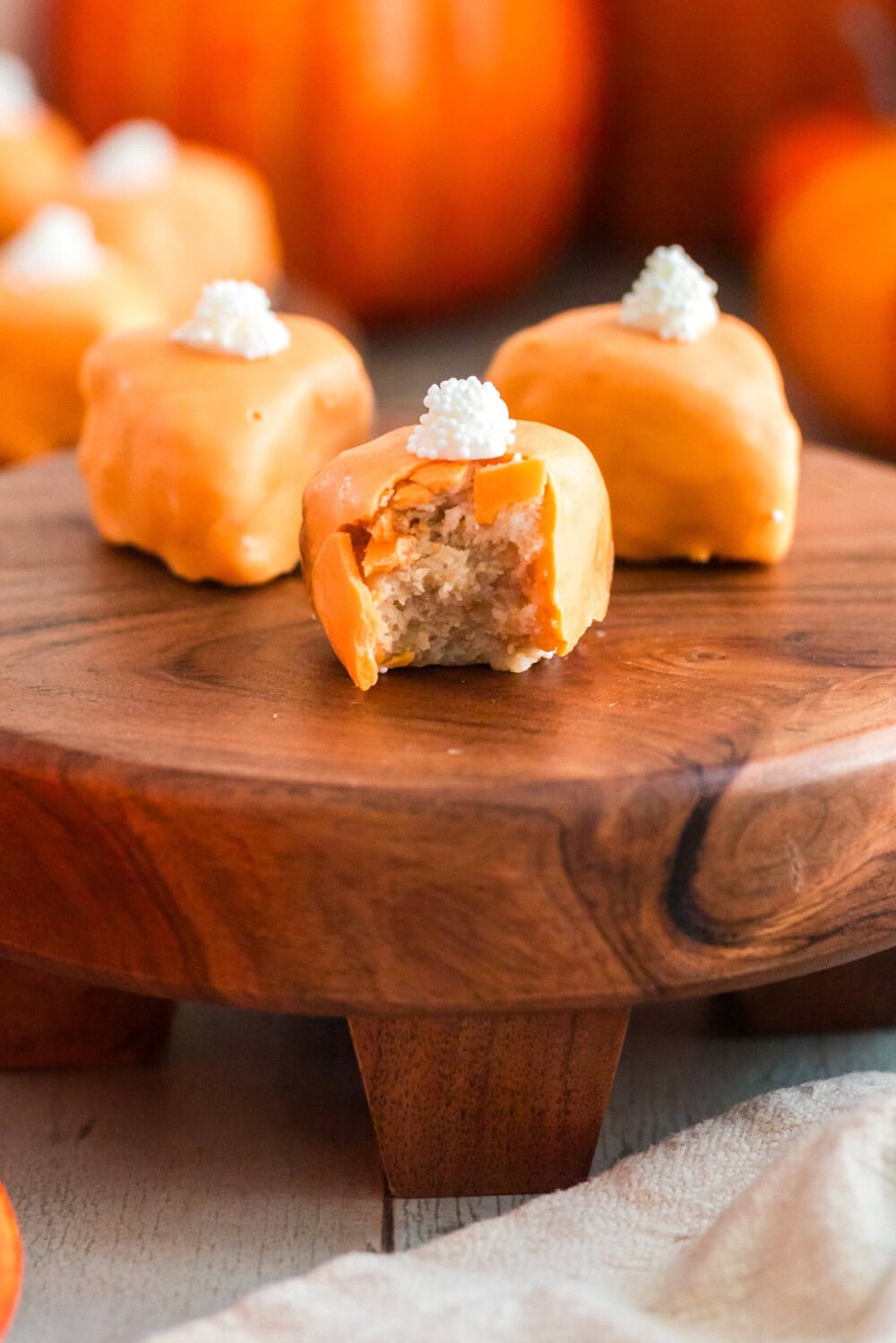 Cake bites that look like pumpkin pie slices on a board.