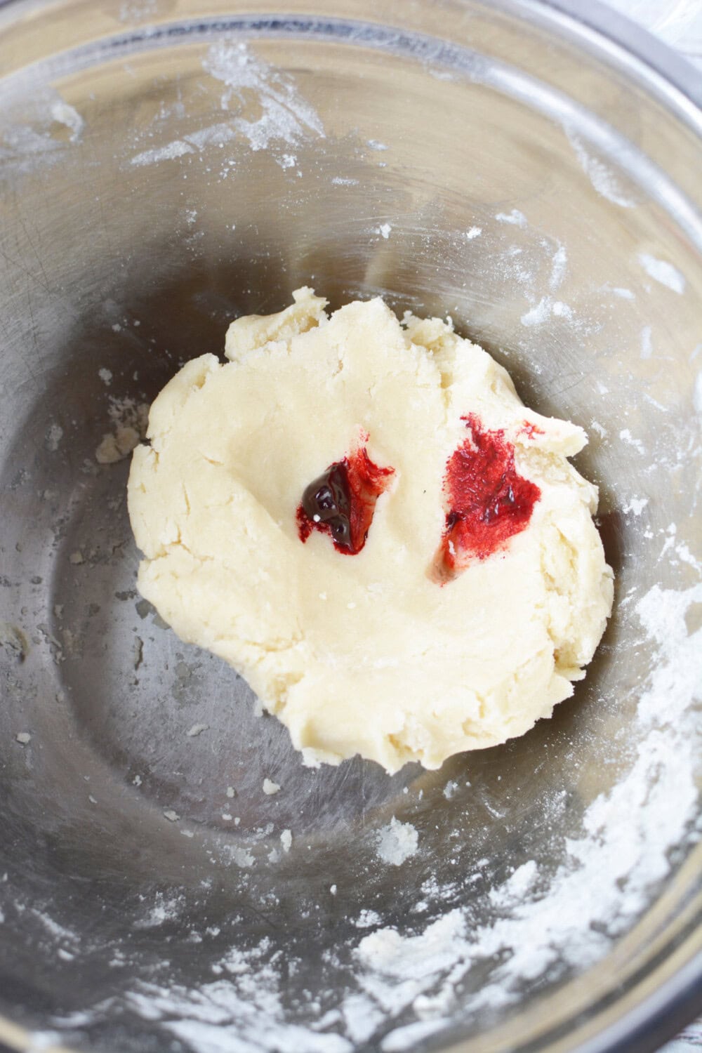 drops of red food coloring on cookie dough ball