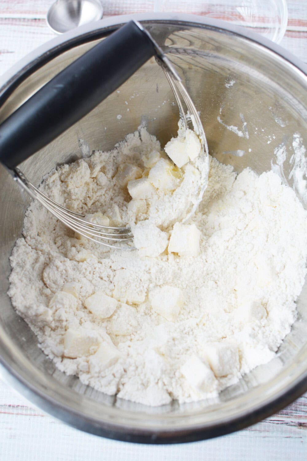 using a pastry blender to cut butter into flour mixture