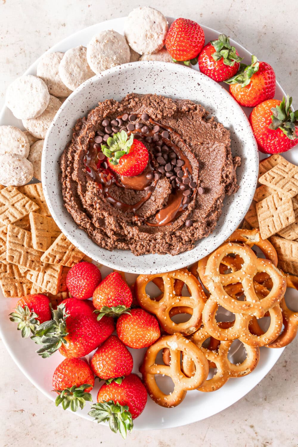 Bowl of chocolate hummus surrounded by dippers.