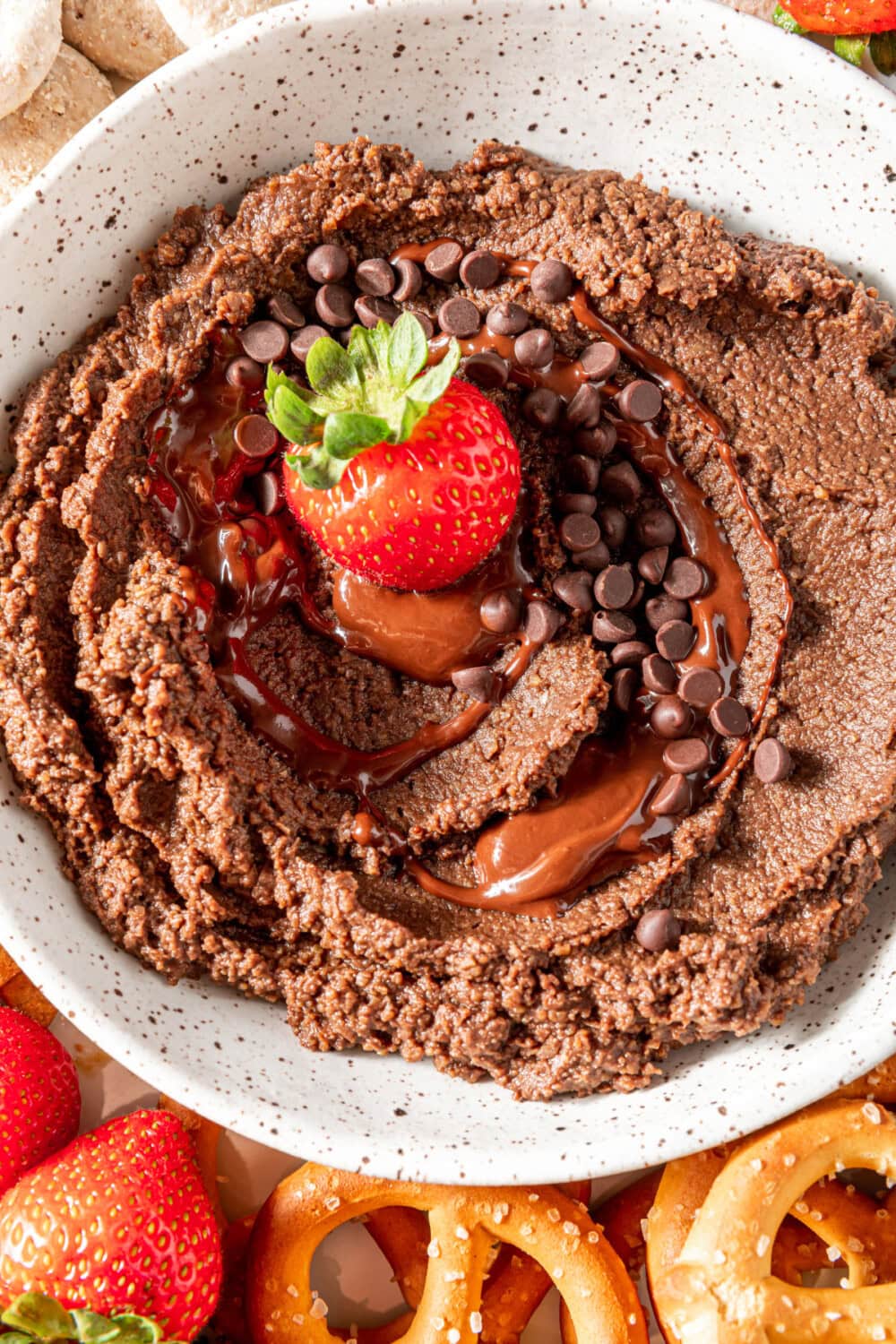 Chocolate hummus in a bowl with a strawberry on top. 