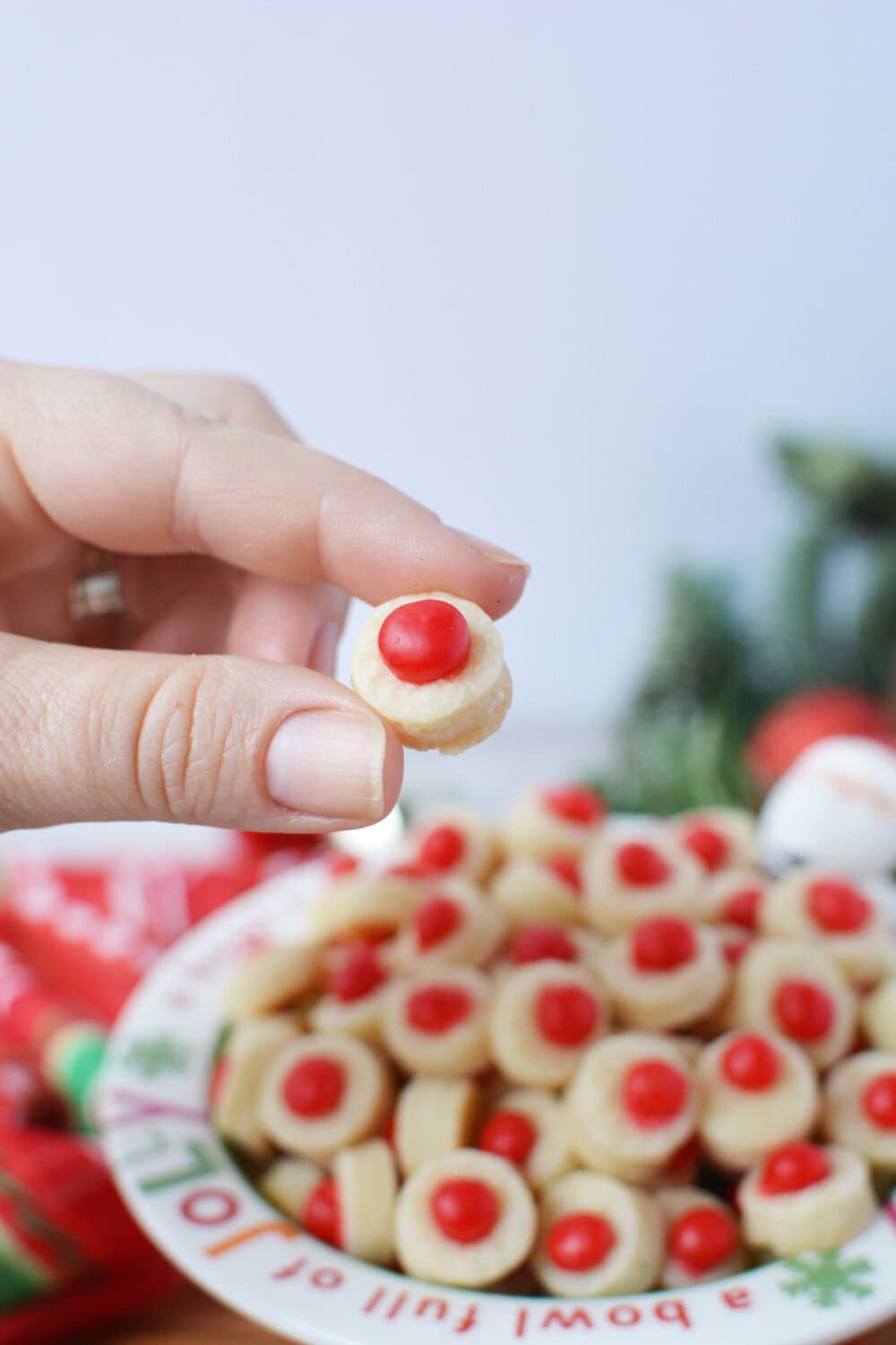 Holding a santa's button shortbread bite