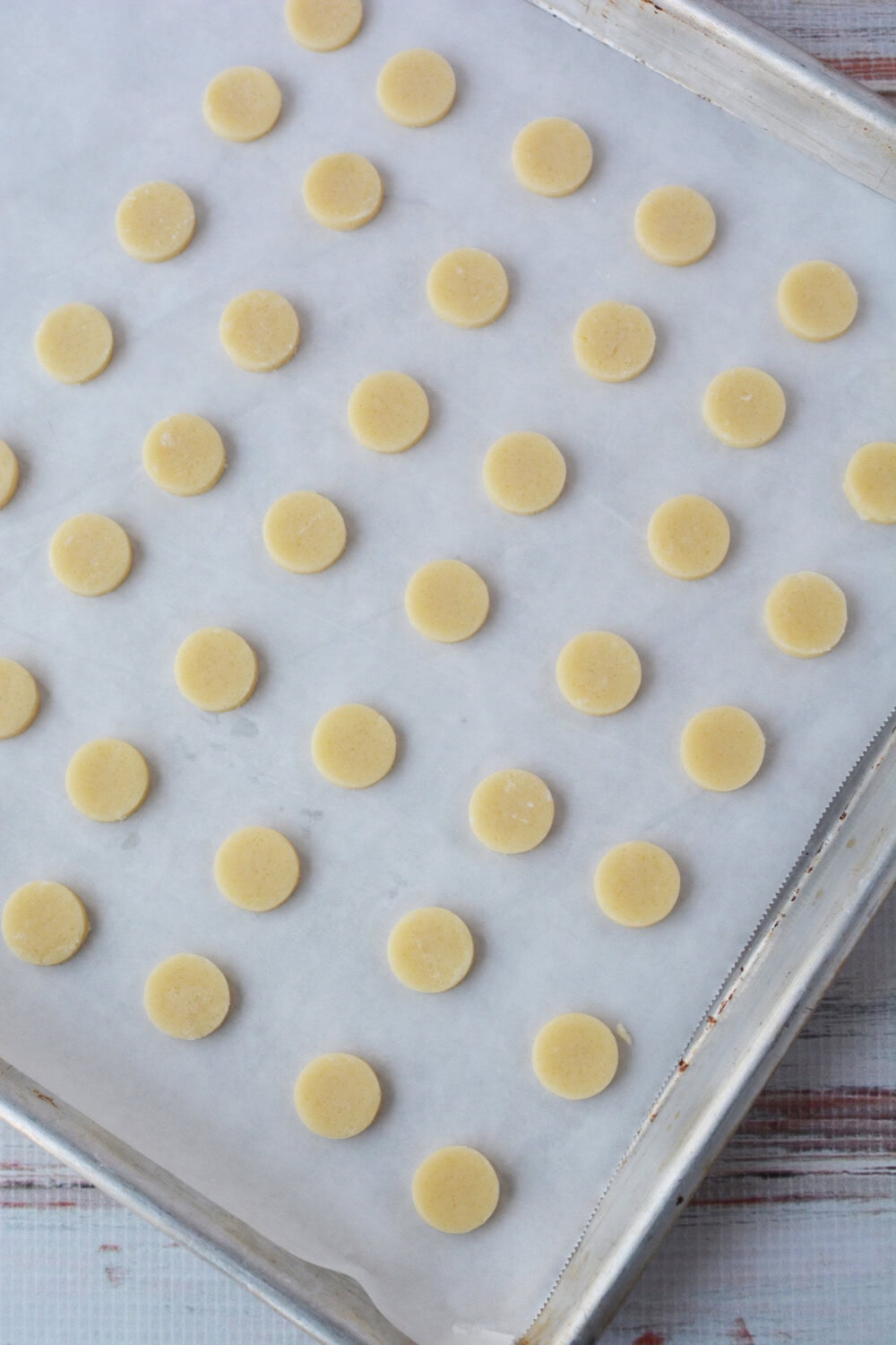 Small dots of cookie dough on a baking sheet