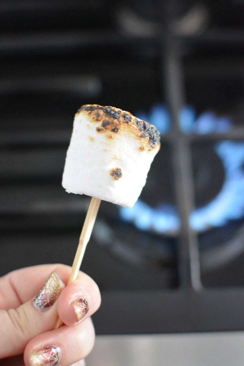 Toasting a marshmallow on a gas stove