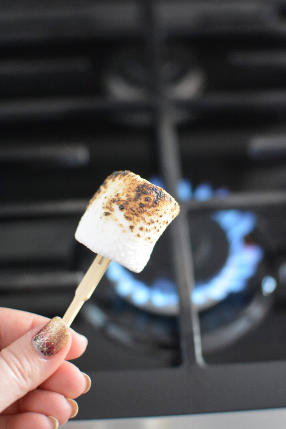 Toasted marshmallow above a gas stove