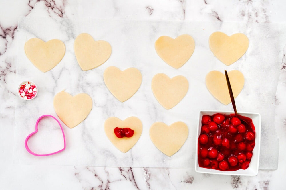 Cherry pie filling on little heart-shaped pie crusts.