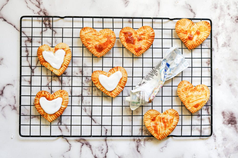 Heart pastries on a wire rack.