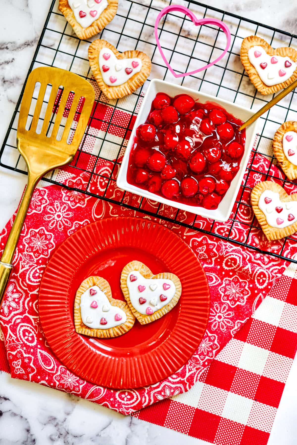 Heart-shaped pastries on a plate with ingredients above it.