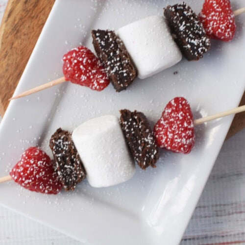 Brownies, marshmallows, and raspberries on a skewer.