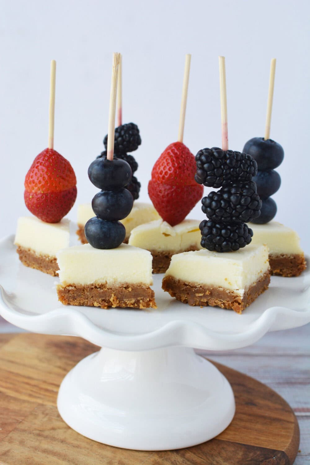 Serving tray of cheesecake berry dessert kabobs.