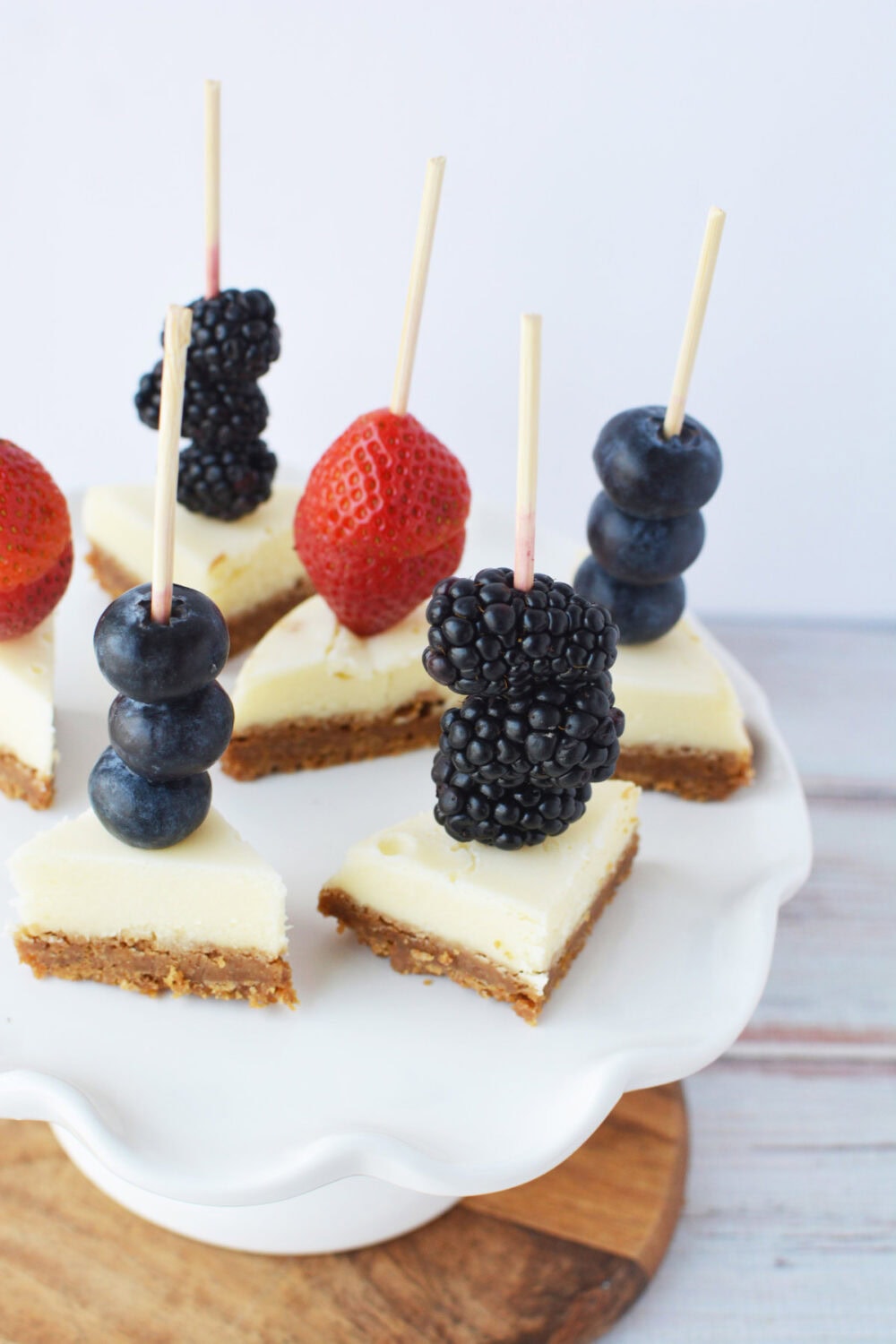 Cheesecake kabobs on a serving platter.