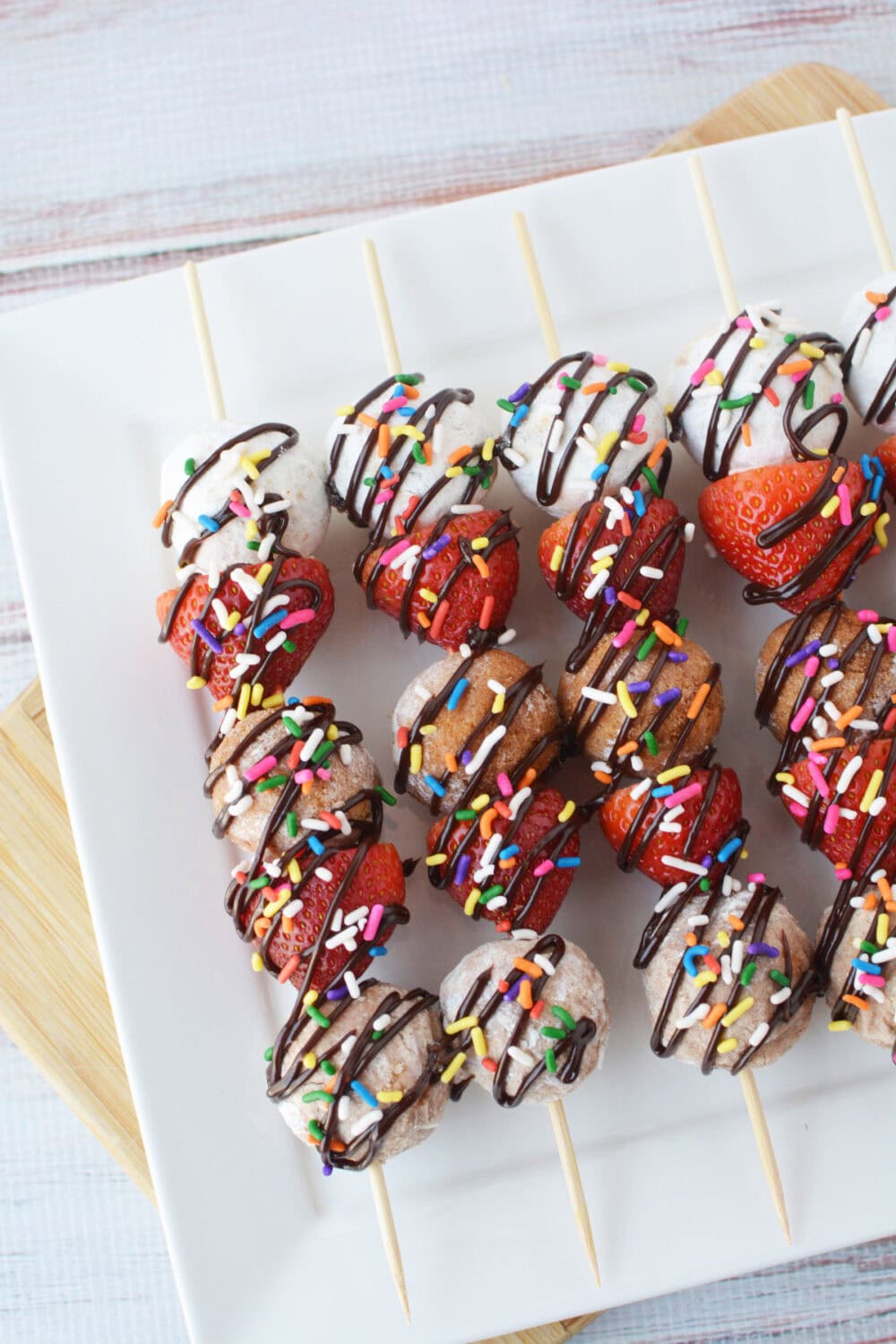 Donut kabobs on a serving tray.