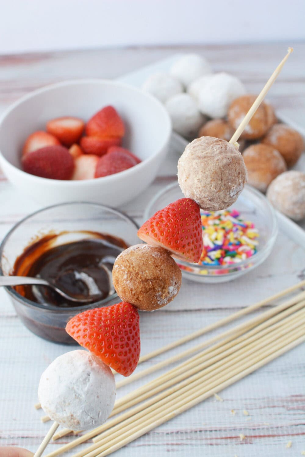 Donut hole skewer with strawberries.