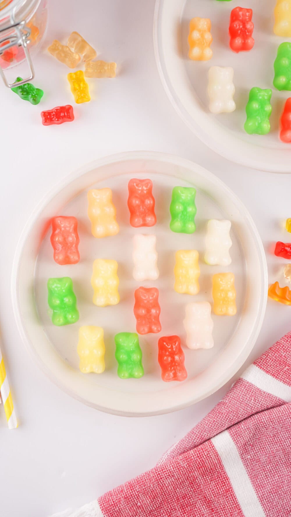 Plate of yellow, green, white, and pink frozen gummy bears.