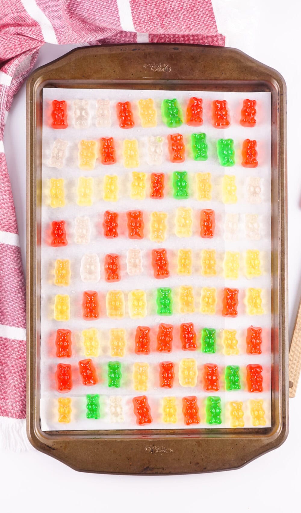 Gummy bears soaked in Sprite on a baking sheet.