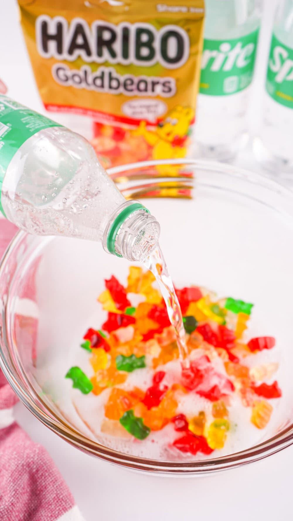 Pouring sprite on gummy bears.