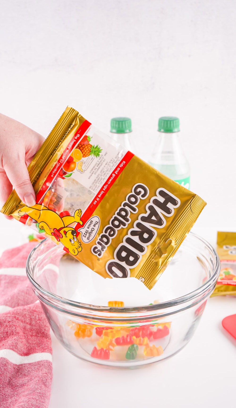 Pouring gummy bears into a bowl.