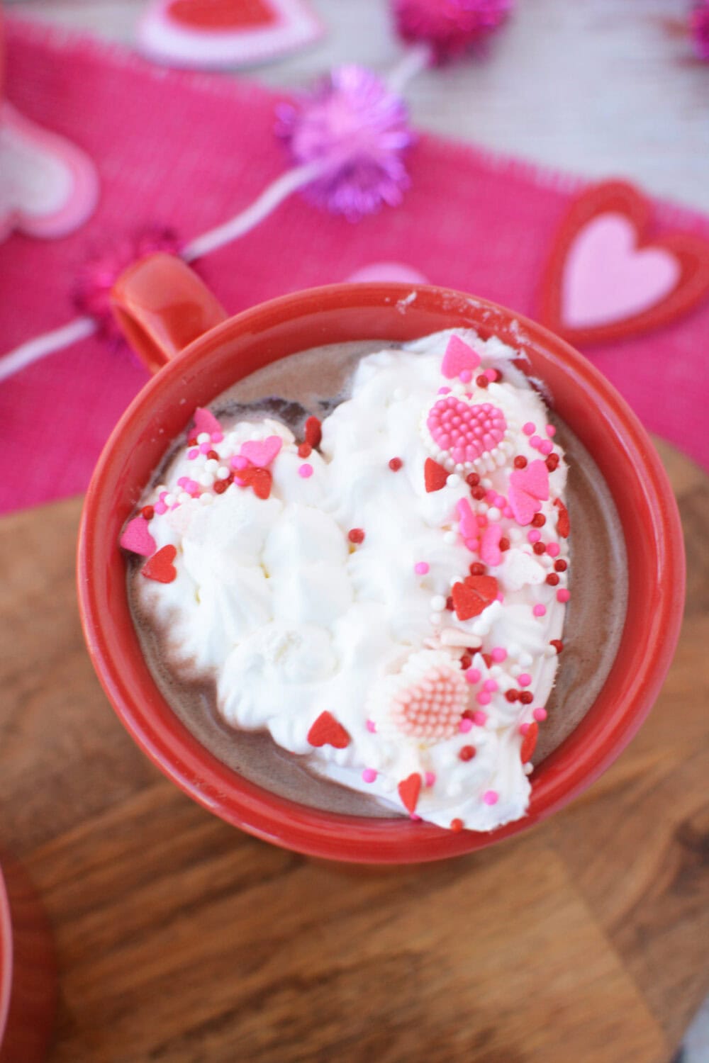 Heart-shaped frozen whipped cream in a mug of hot cocoa. 