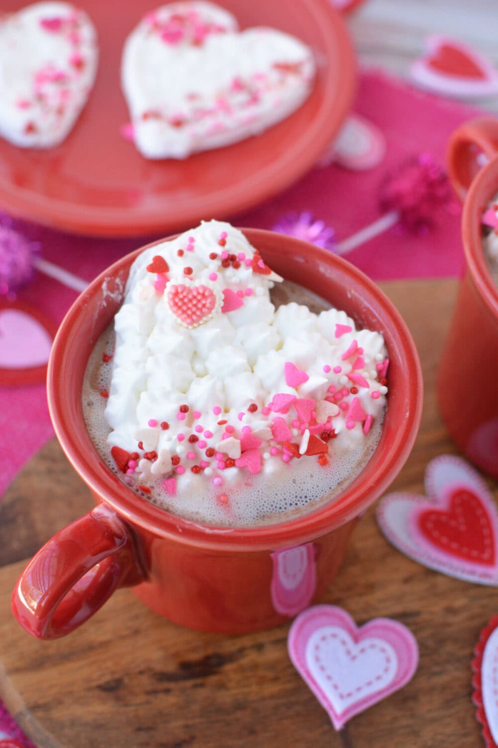 Heart hot cocoa whipped cream topper on a mug. 