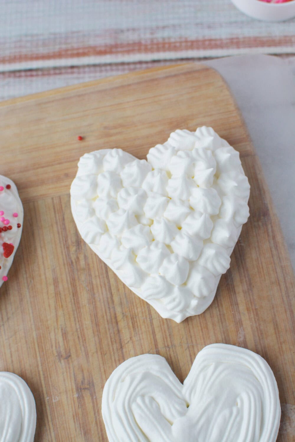 Adding a pattern to whipped cream hearts. 