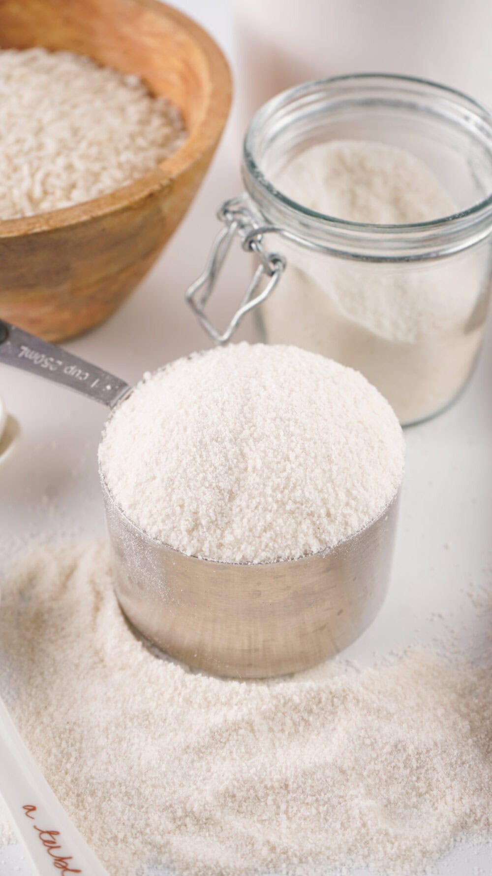 Measuring cup filled with homemade rice flour.