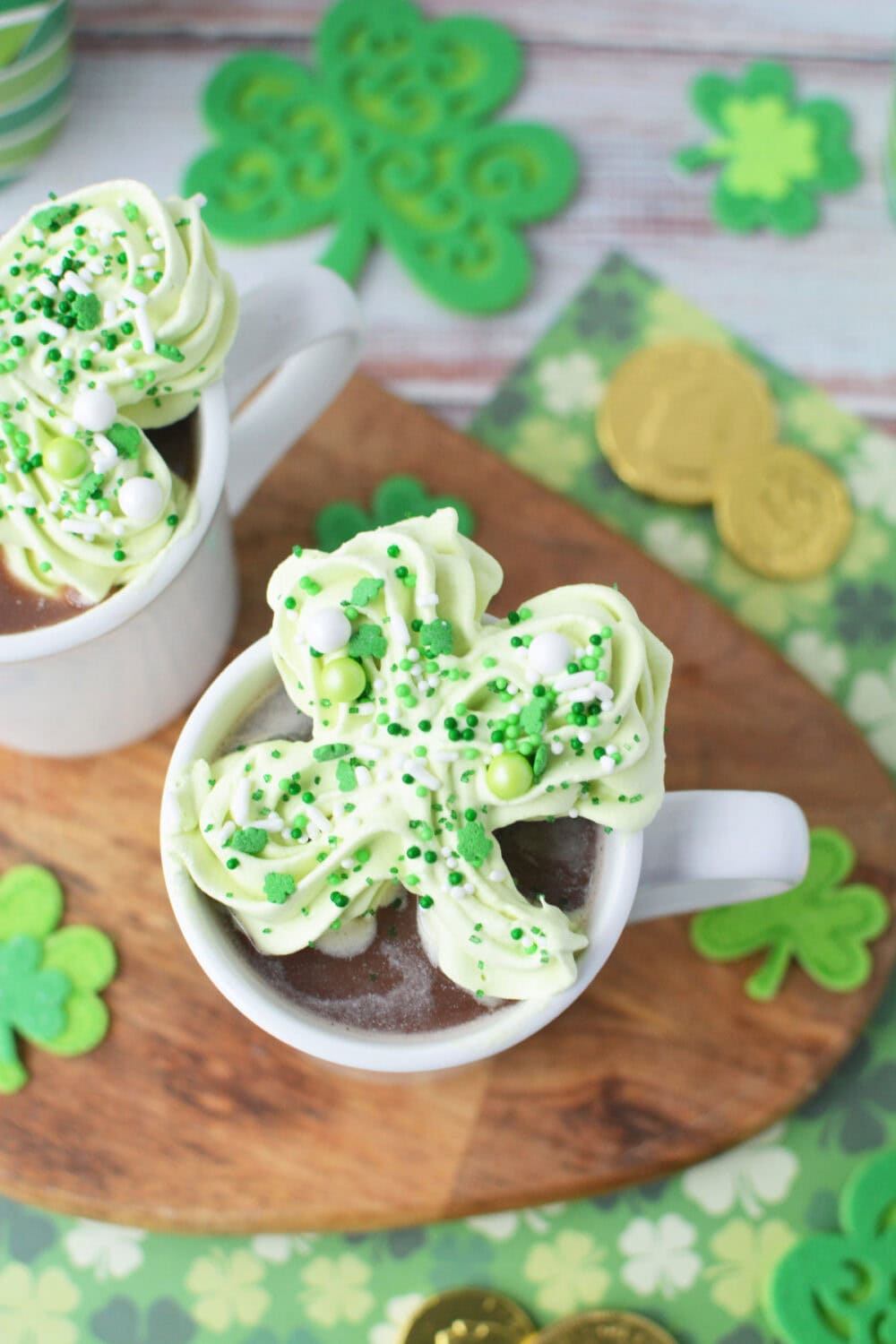 Green St. Patrick's Day whipped cream topper in a mug of hot cocoa.