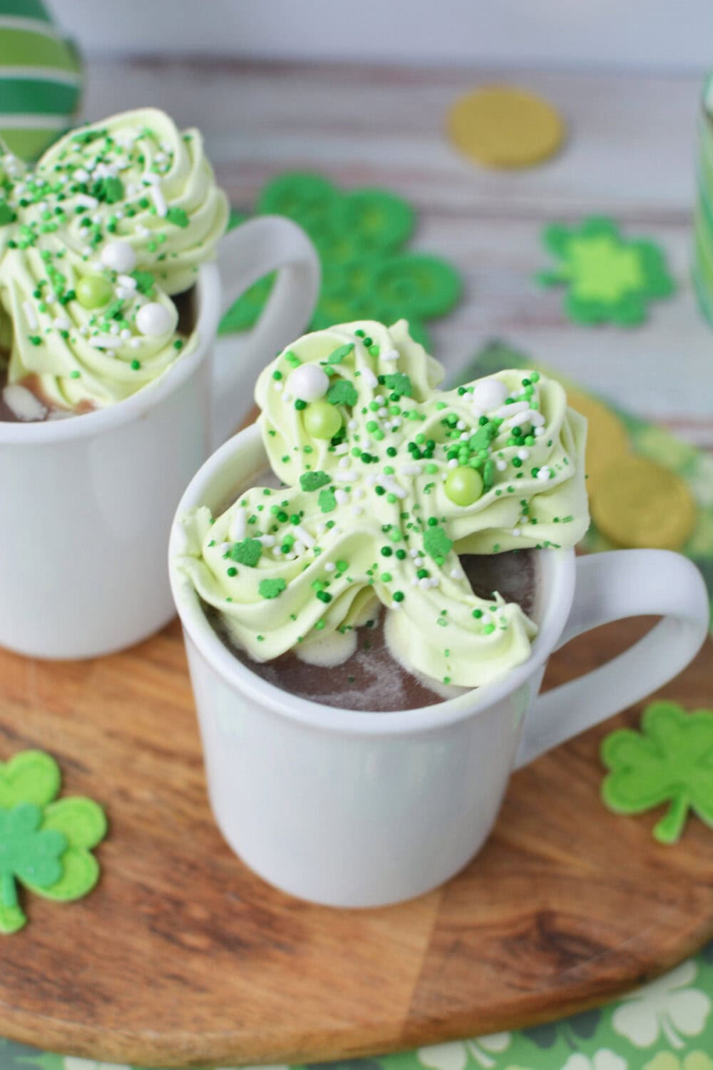 Shamrock whipped topper for hot chocolate in a mug.