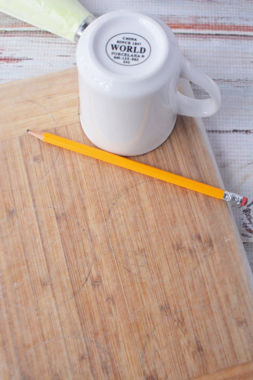 Tracing a mug on wax paper.