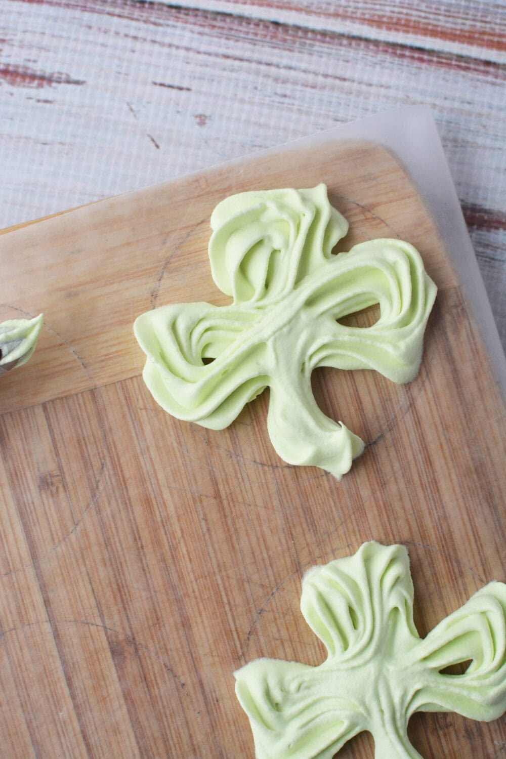 Whipped cream shamrock on waxed paper.