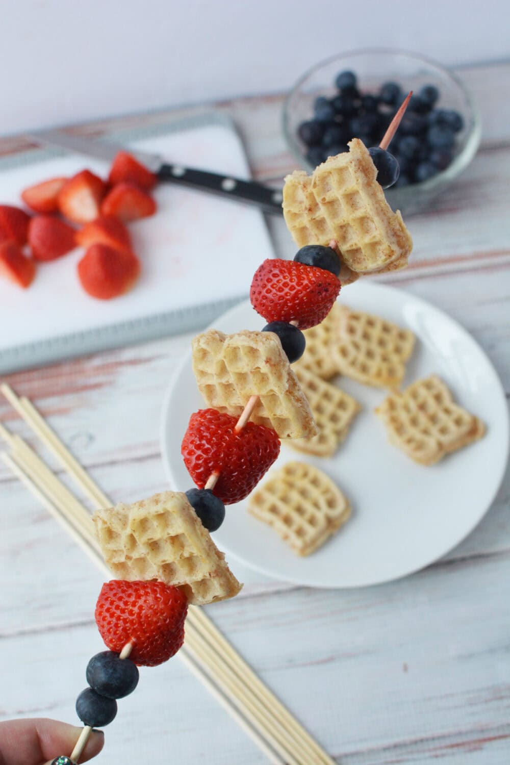 Mini waffles and berries on a stick.