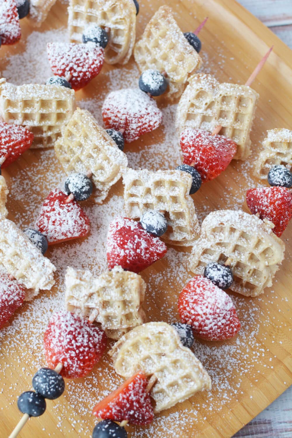 Berries and mini waffles on skewer sticks.