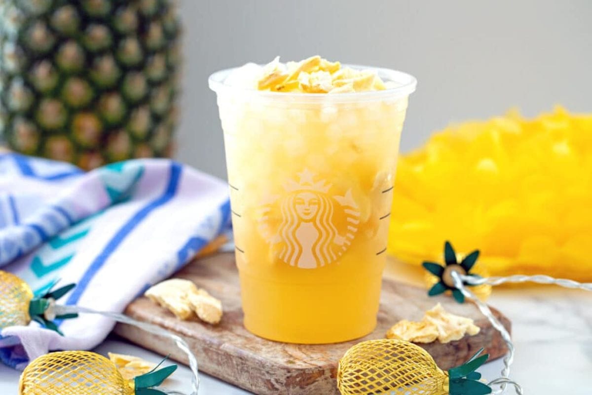 Cup of pineapple passionfruit drink.