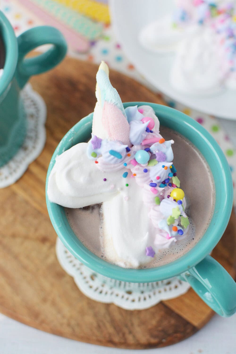 Unicorn shaped whipped cream in a mug of hot cocoa.