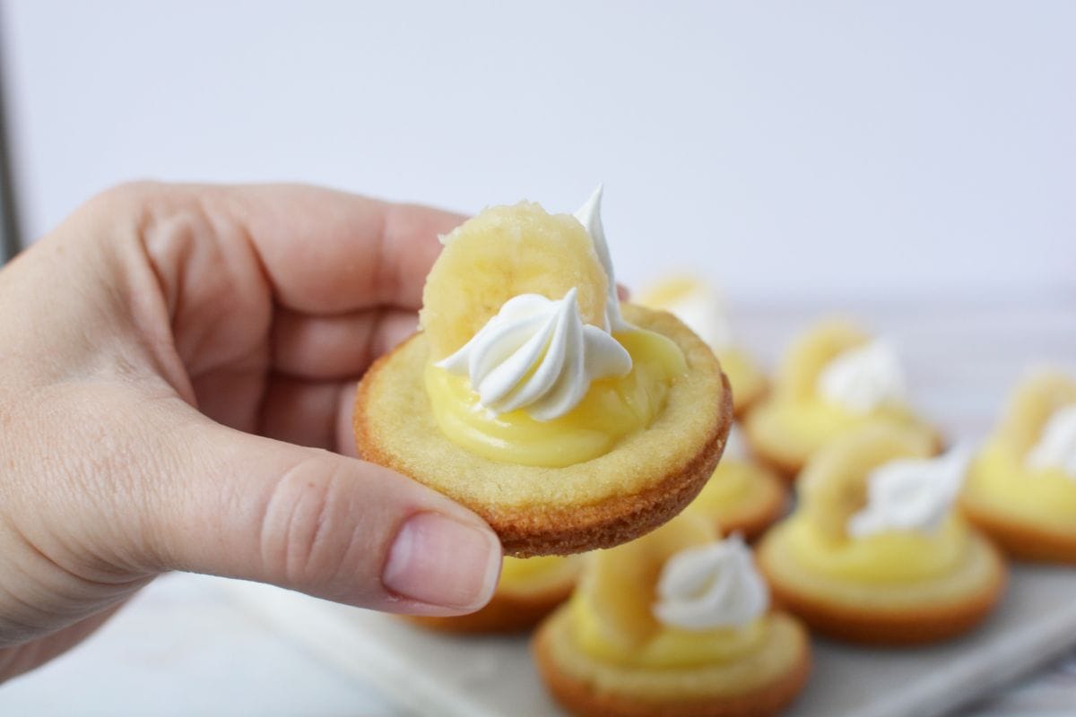 a hand holding a banana cream pie cookie