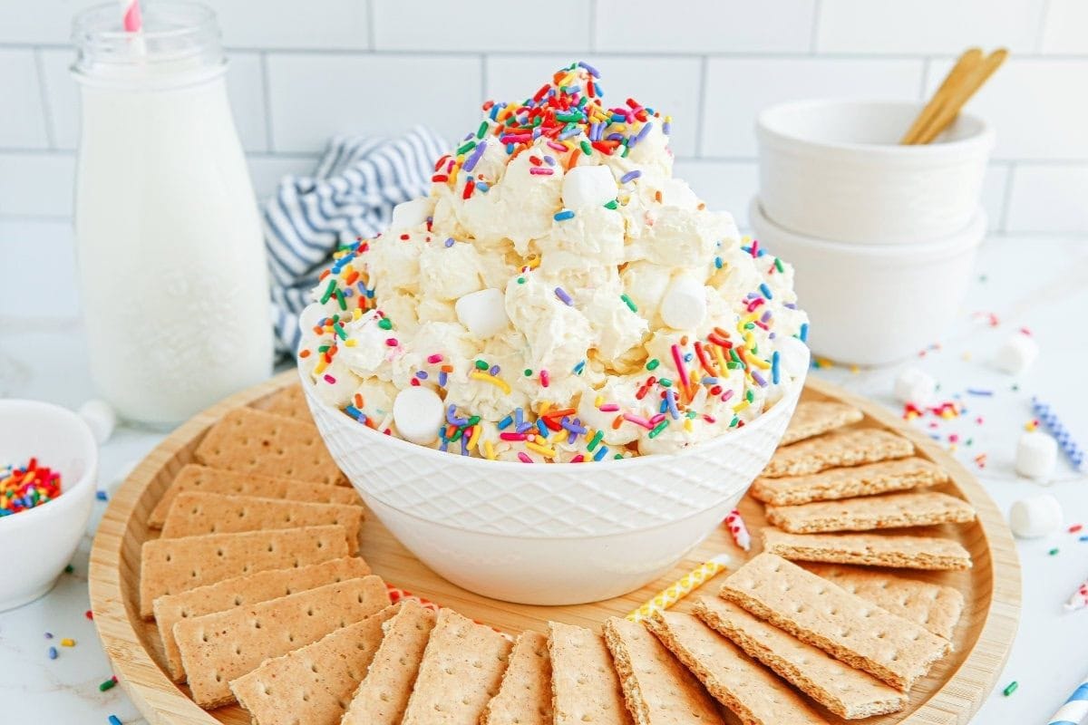 bowl of birthday cake fluff salad with graham crackers around it