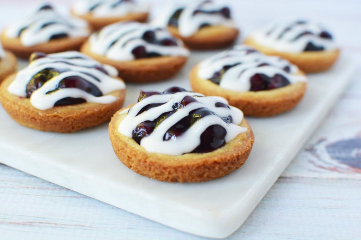 blueberry pie cookies with glaze topping on a tray